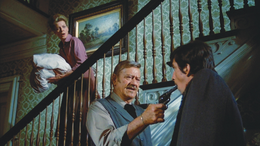 "Make like that's a nipple." J.B. Books (John Wayne) makes clear his displeasure with a proposition from a newspaper man (Rick Lenz) as his landlady (Lauren Bacall) looks on with horror in "The Shootist."